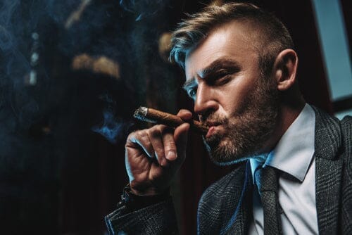 man in suit smoking a cigar