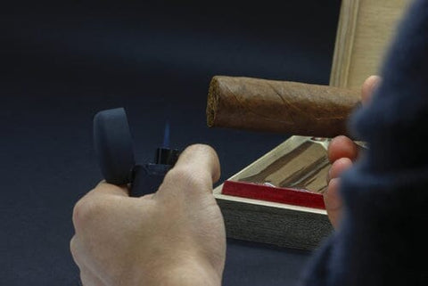 soft flame lighter lighting a cigar