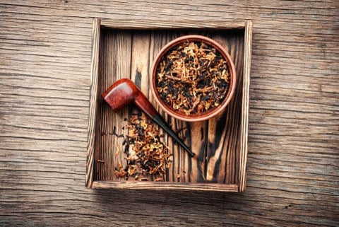 pipe tobacco laying next to tobacco blend in a square box
