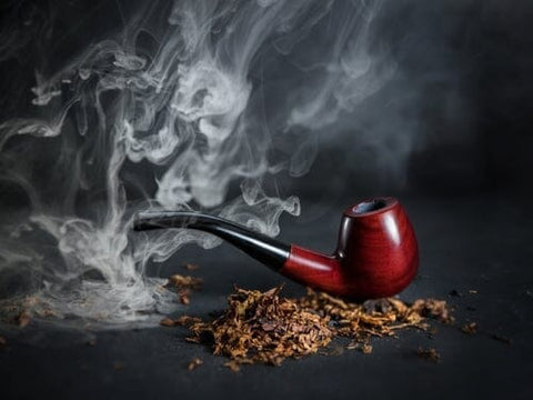 pipe tobacco smoking next to a pile of loose tobacco