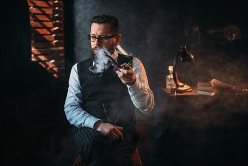 man smoking from an extra large pipe